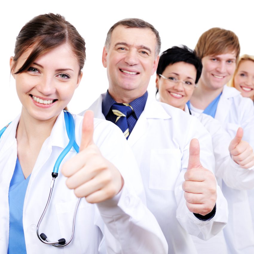 group of happy laughing doctors with gesture thumbs-up standing in line